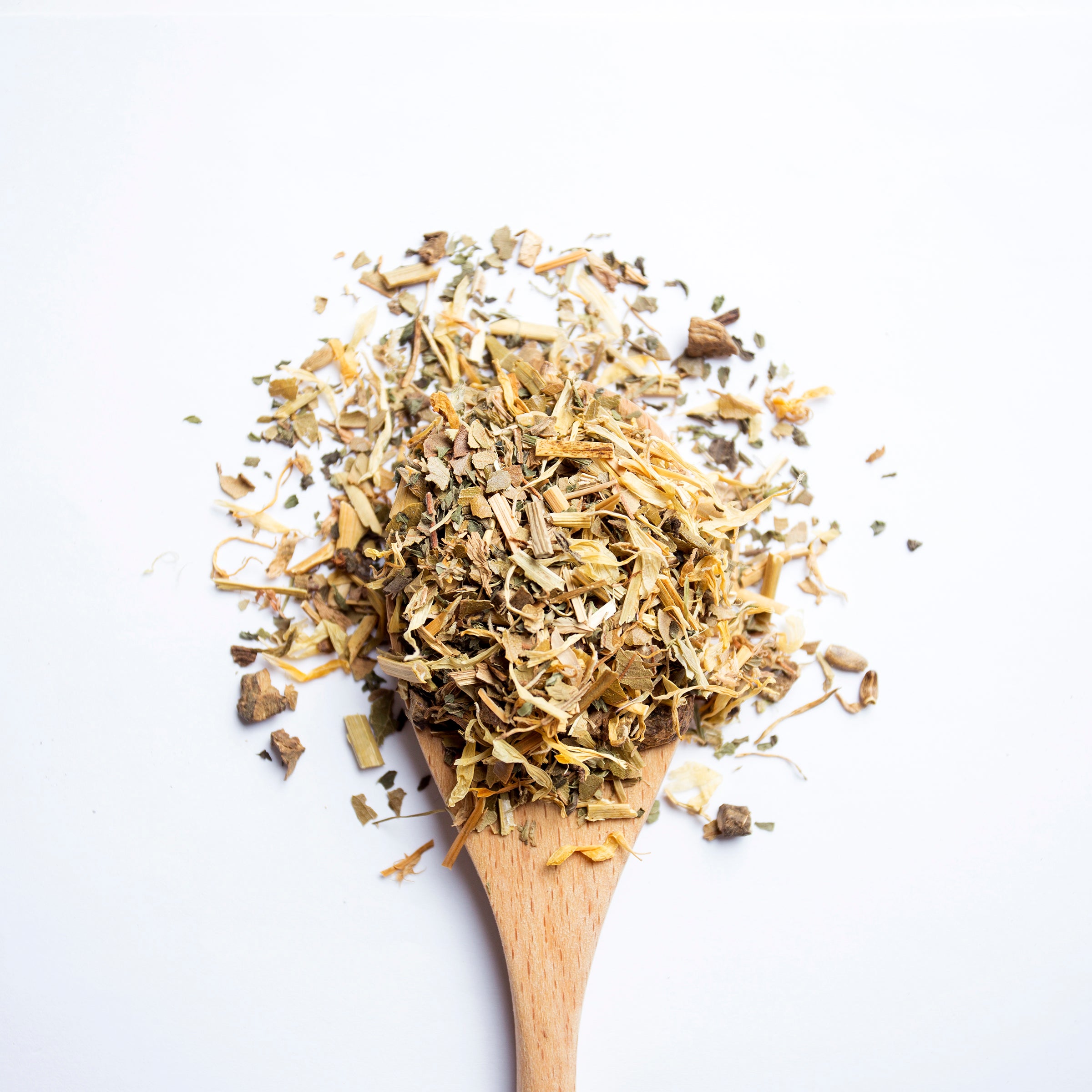 Organic herbal Complexion Beauty tea blend with roots and herbs on wooden spoon