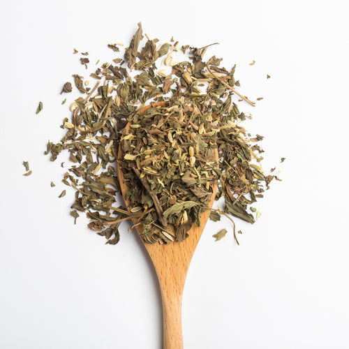 Organic herbal Liver Detox tea blend with roasted dandelion root, chicory and turmeric on wooden spoon